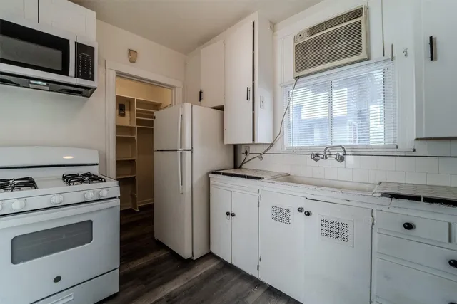 a kitchen with stainless steel appliances granite countertop a refrigerator stove and microwave