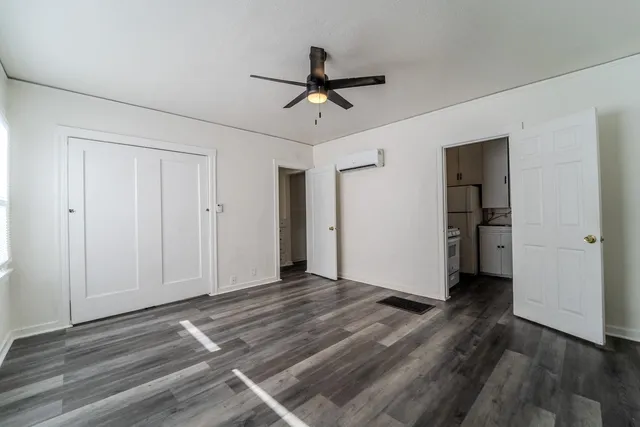 a view of empty room with wooden floor