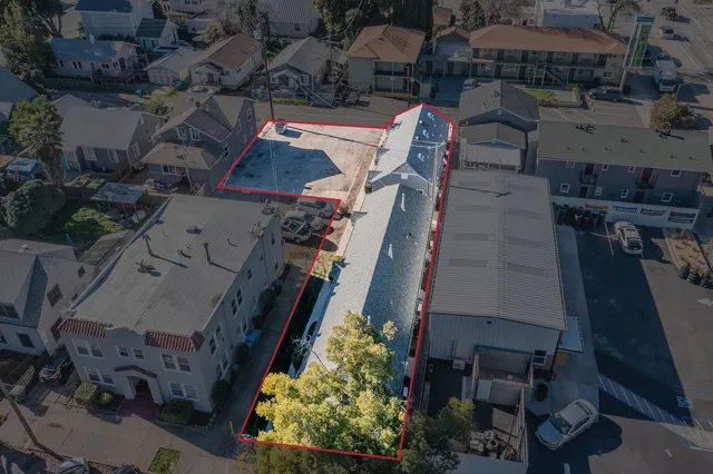 an aerial view of a house with a yard basket ball court and outdoor seating