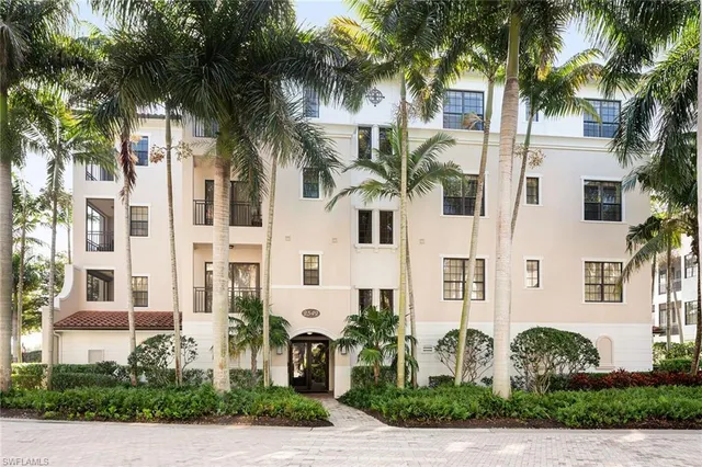 a front view of multiple houses with yard