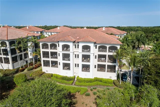 an aerial view of residential houses with outdoor space and river