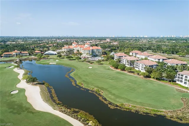 an aerial view of residential houses with outdoor space and river