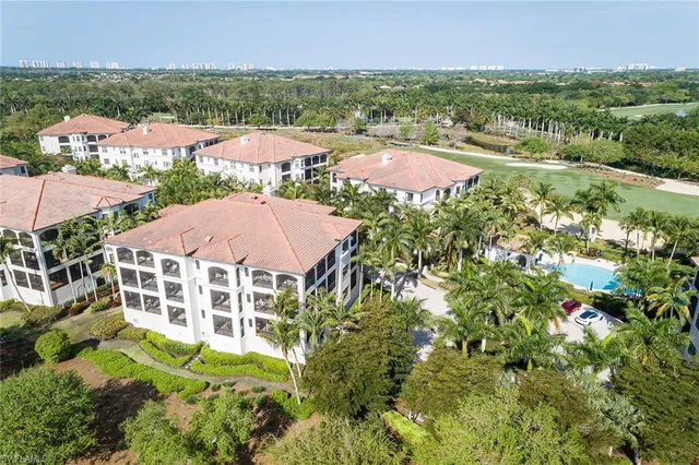 an aerial view of residential houses with outdoor space and river
