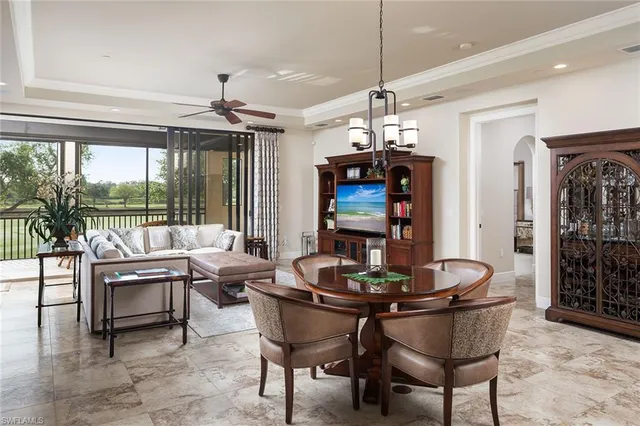 a dining room with furniture a chandelier and window