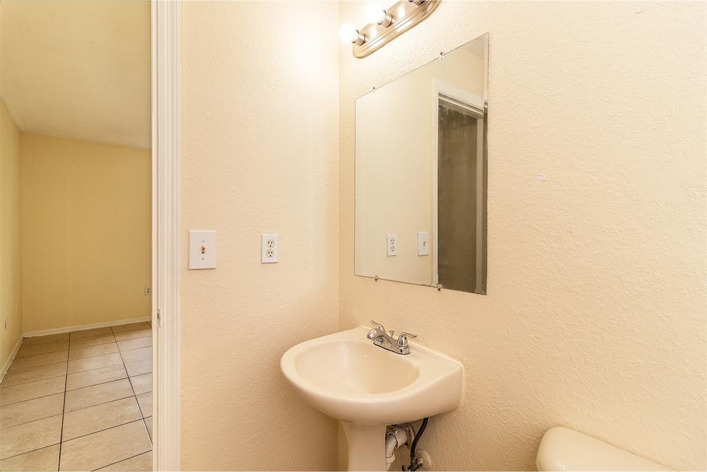 2214 Northwest 135th Terrace Opa-Locka, FL 33054 - Photo 20 of 29 a bathroom with a sink and a mirror
