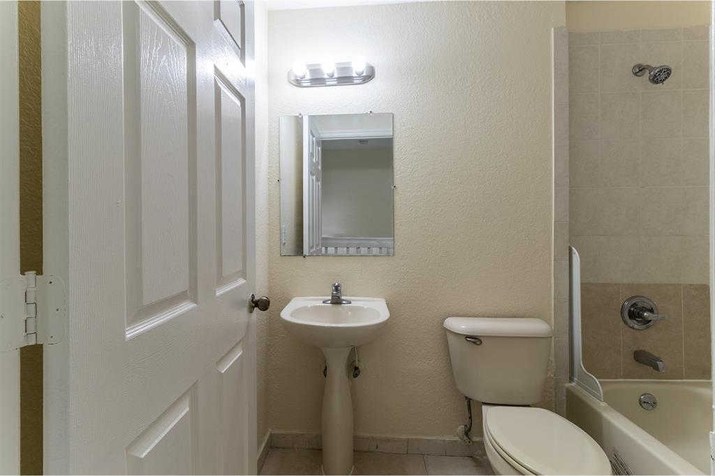 2214 Northwest 135th Terrace Opa-Locka, FL 33054 - Photo 23 of 29 a bathroom with a sink toilet and shower