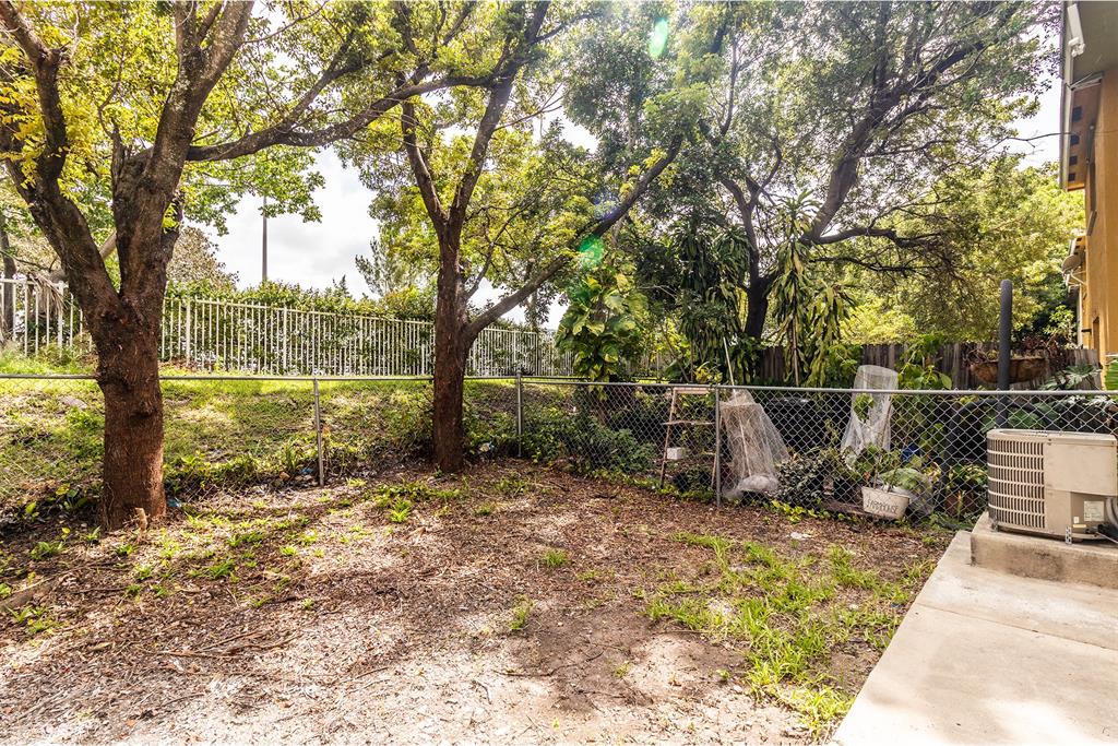 2214 Northwest 135th Terrace Opa-Locka, FL 33054 - Photo 29 of 29 a view of a park with large trees and wooden fence