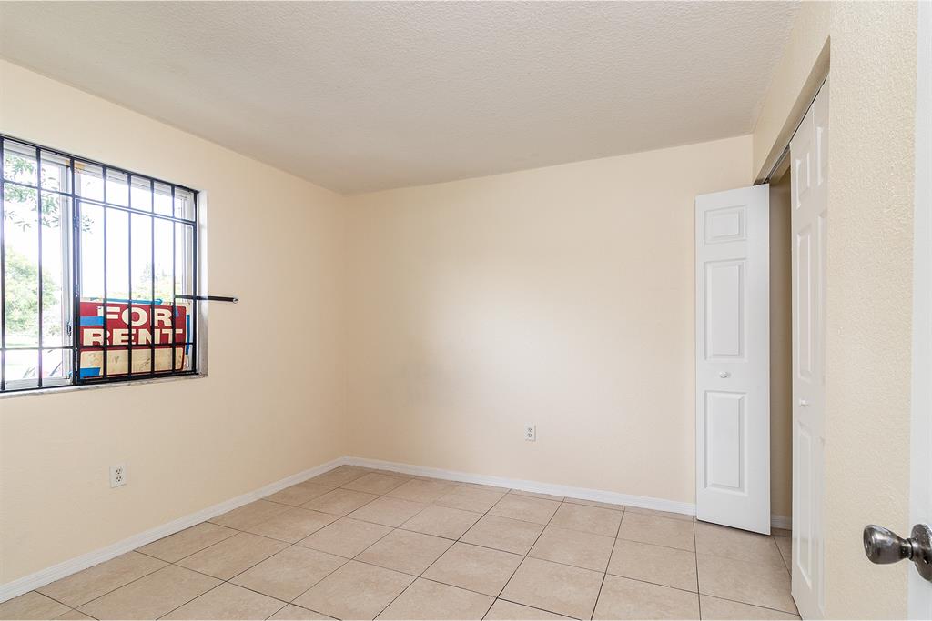 2214 Northwest 135th Terrace Opa-Locka, FL 33054 - Photo 4 of 29 an empty room with windows