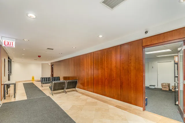 a view of a living room a dining room wooden floor and a large window