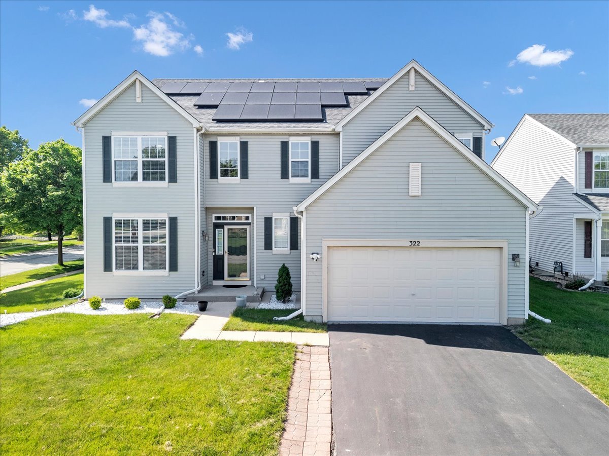 322 Zinnia Drive Romeoville, IL 60446 - Photo 1 of 42 a front view of a house with a yard outdoor seating and garage
