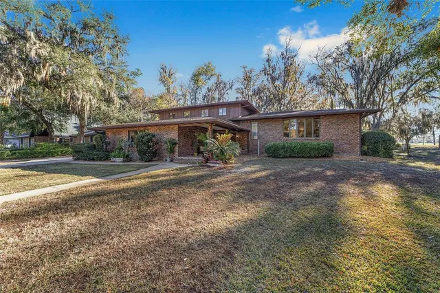 a front view of house with yard and green space