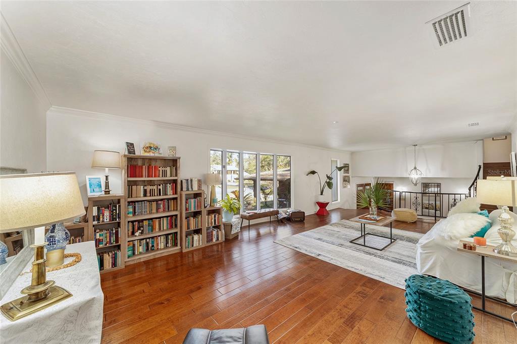 6015 Southwest 36th Way Gainesville, FL 32608 - Photo 19 of 67 a living room with furniture and a book shelf