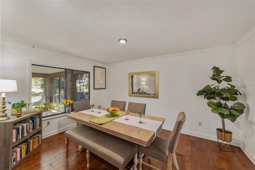 6015 Southwest 36th Way Gainesville, FL 32608 - Photo 22 of 67 a view of a dining room with furniture window and wooden floor