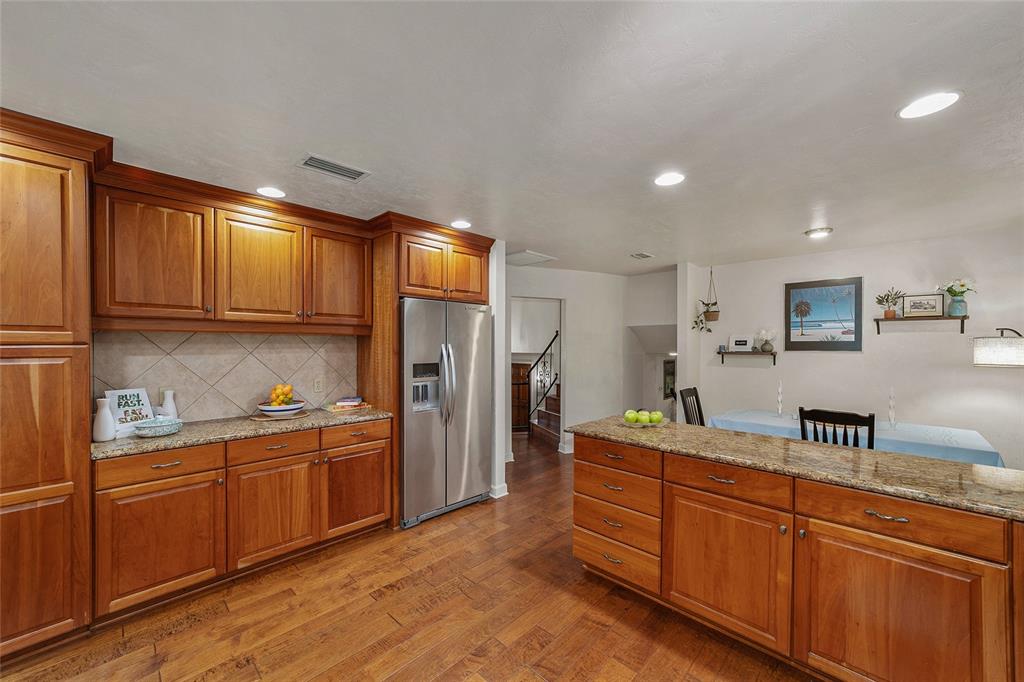 6015 Southwest 36th Way Gainesville, FL 32608 - Photo 24 of 67 a kitchen with stainless steel appliances granite countertop a refrigerator and a sink