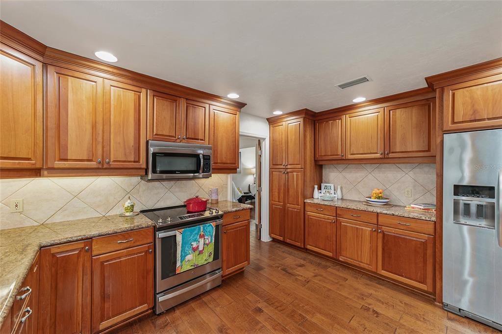6015 Southwest 36th Way Gainesville, FL 32608 - Photo 26 of 67 a kitchen with stainless steel appliances granite countertop a refrigerator stove and sink