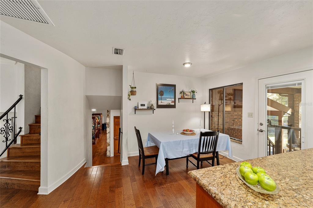 6015 Southwest 36th Way Gainesville, FL 32608 - Photo 28 of 67 a view of a dining room with furniture and wooden floor