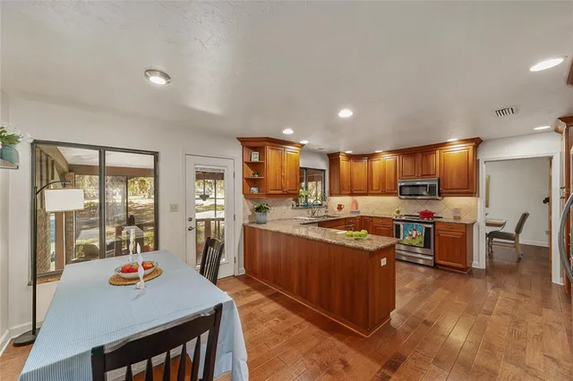 a bathroom with a granite countertop toilet sink shower and mirror