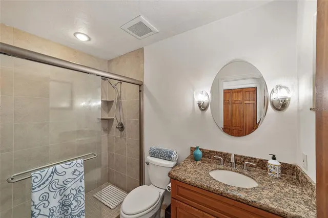 a bedroom that has a bed and a chair in it