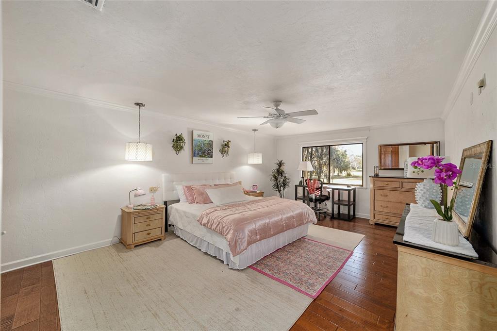 6015 Southwest 36th Way Gainesville, FL 32608 - Photo 37 of 67 a bedroom with a bed furniture and a potted plant