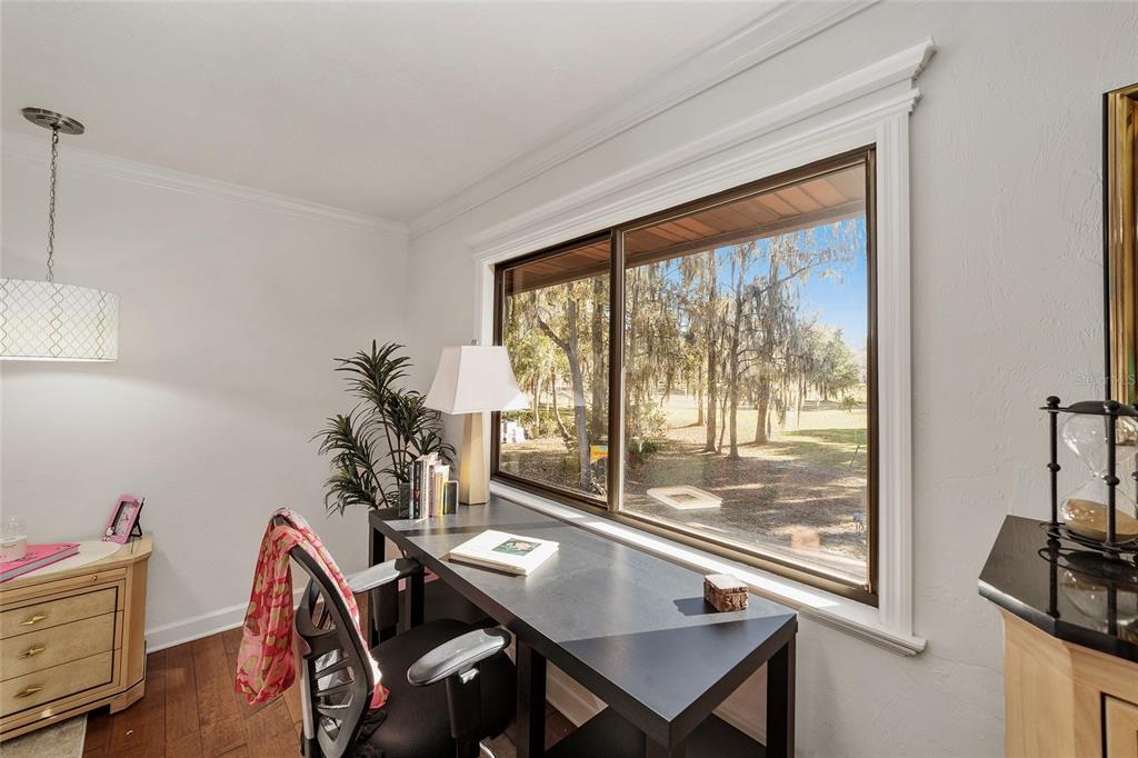 6015 Southwest 36th Way Gainesville, FL 32608 - Photo 38 of 67 a view of a workspace with furniture and a window