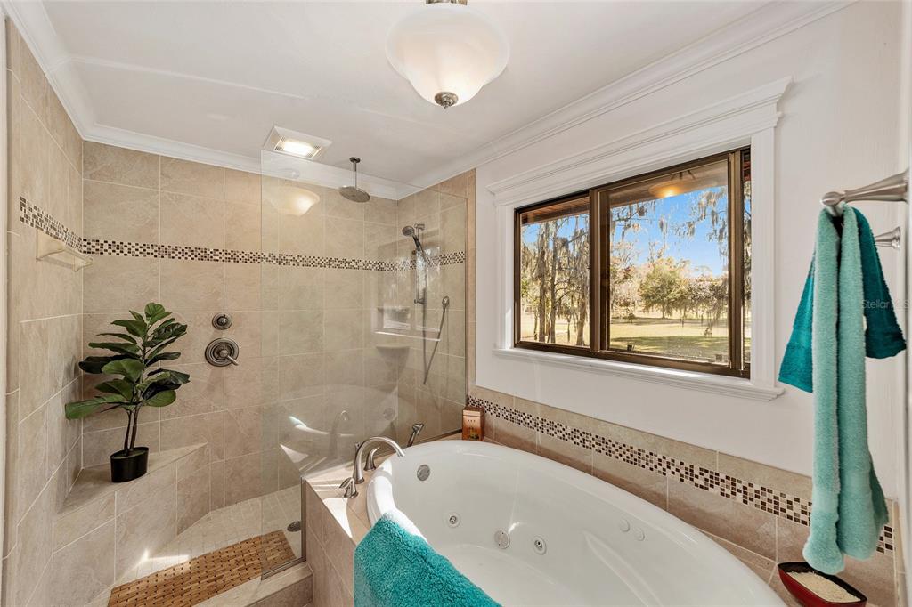 6015 Southwest 36th Way Gainesville, FL 32608 - Photo 41 of 67 a bathroom with a tub a sink and a window