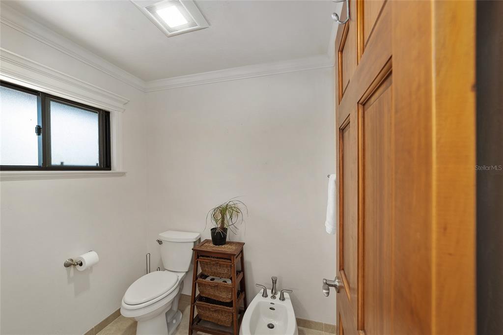 6015 Southwest 36th Way Gainesville, FL 32608 - Photo 42 of 67 a white toilet sitting next to a bathroom sink and vanity