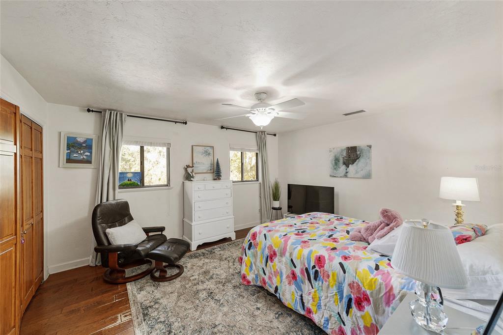 6015 Southwest 36th Way Gainesville, FL 32608 - Photo 43 of 67 a bedroom that has a bed and a chair in it