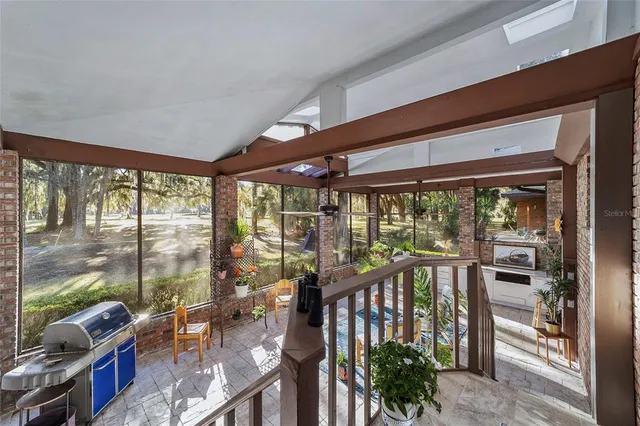 an aerial view of house with yard and mountain view in back
