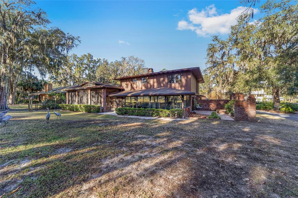 6015 Southwest 36th Way Gainesville, FL 32608 - Photo 56 of 67 a view of a big house with large trees and a big yard