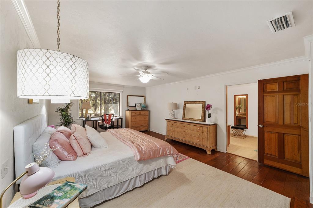 6015 Southwest 36th Way Gainesville, FL 32608 - Photo 8 of 67 a bedroom with a bed and wooden floor
