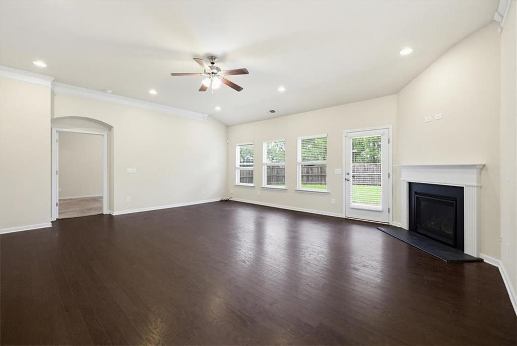 314 Boulder Run Hiram, GA 30141 - Photo 14 of 31 an empty room with wooden floor fan and windows