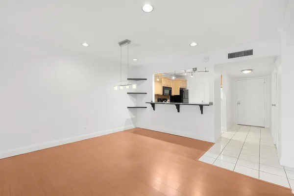 a view of empty room with wooden floor