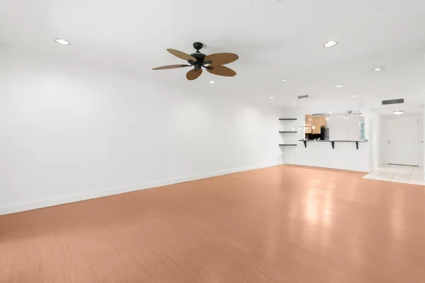 an empty room with a empty space and a ceiling fan