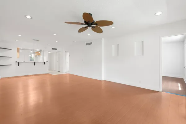 a view of an empty room with a kitchen