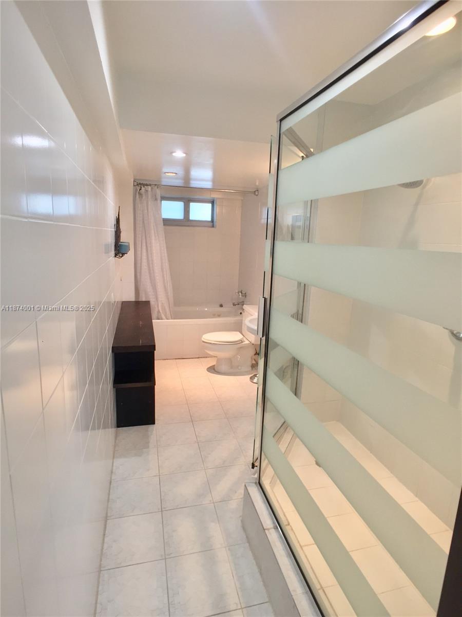 1025 Alton Road, Unit 507 Miami Beach, FL 33139 - Photo 11 of 28 a bathroom with a tub and shower