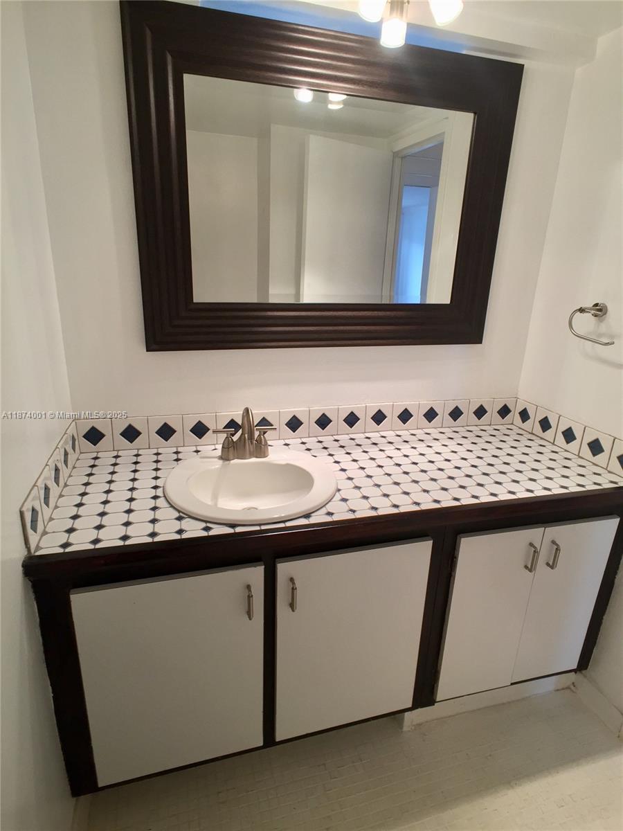 1025 Alton Road, Unit 507 Miami Beach, FL 33139 - Photo 17 of 28 a bathroom with a sink and a mirror