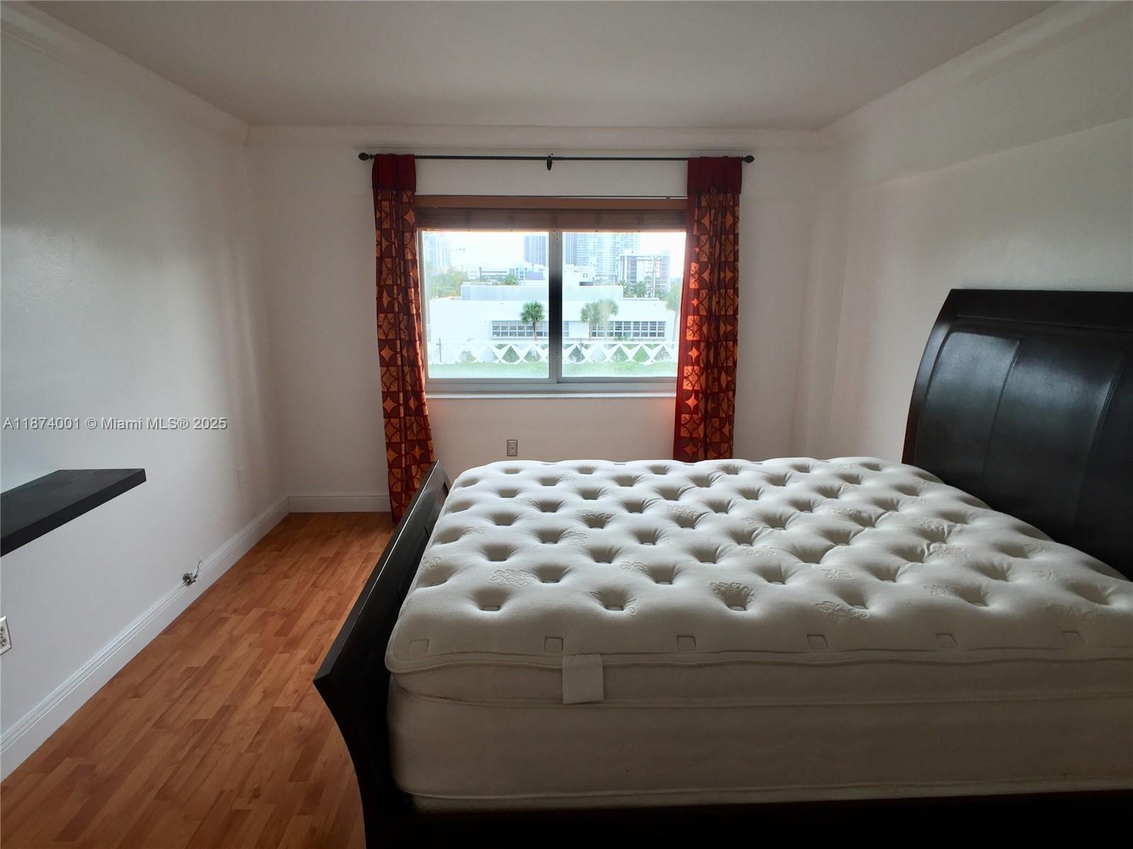 1025 Alton Road, Unit 507 Miami Beach, FL 33139 - Photo 19 of 28 a bedroom with a bed and window