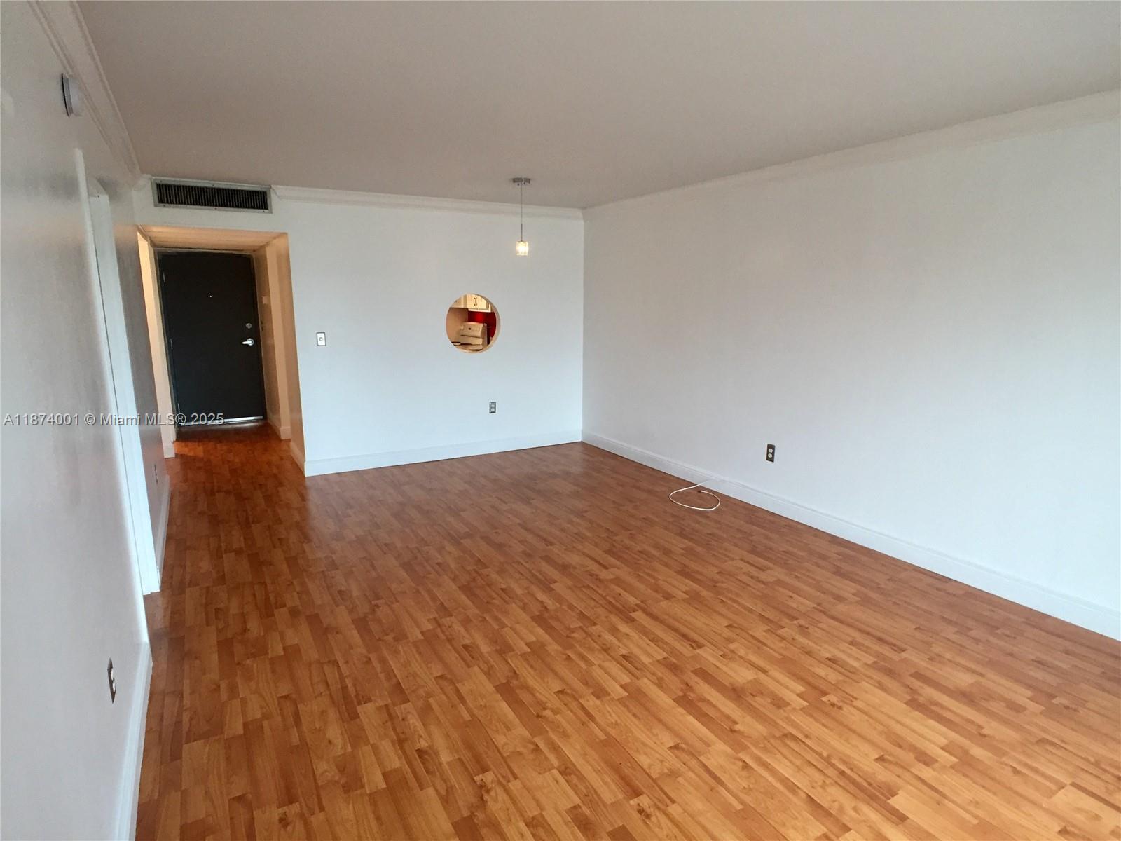 1025 Alton Road, Unit 507 Miami Beach, FL 33139 - Photo 22 of 28 an empty room with wooden floor and windows