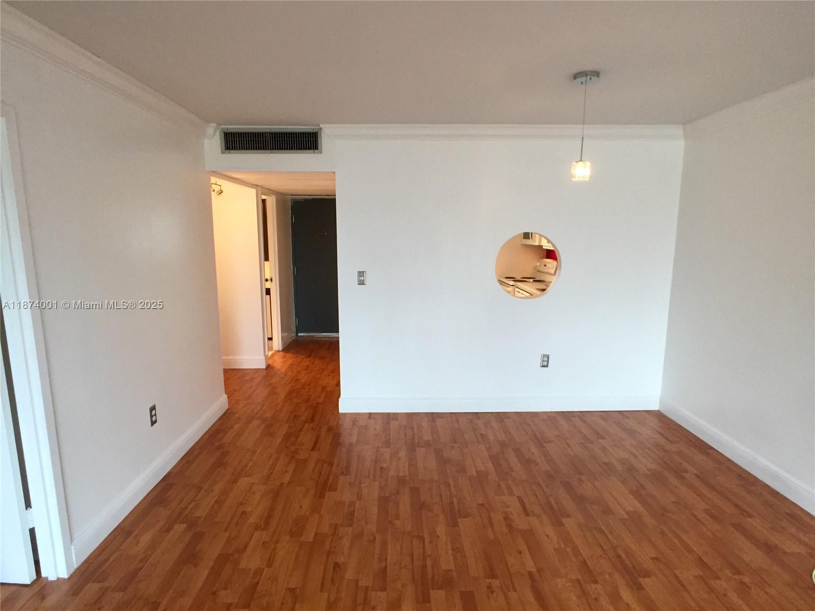 1025 Alton Road, Unit 507 Miami Beach, FL 33139 - Photo 23 of 28 an empty room with wooden floor and mirror