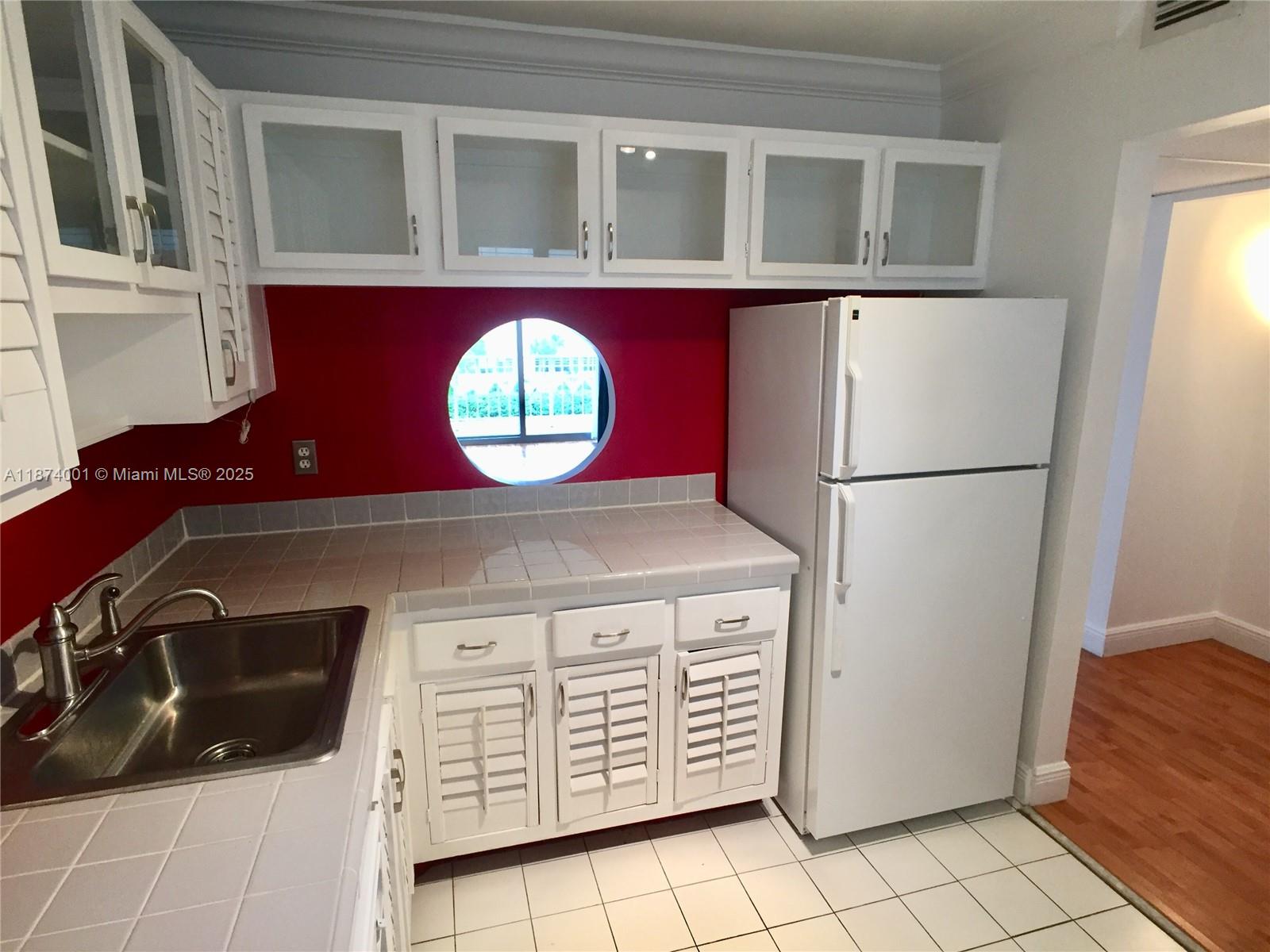 1025 Alton Road, Unit 507 Miami Beach, FL 33139 - Photo 28 of 28 a kitchen with a refrigerator and a stove