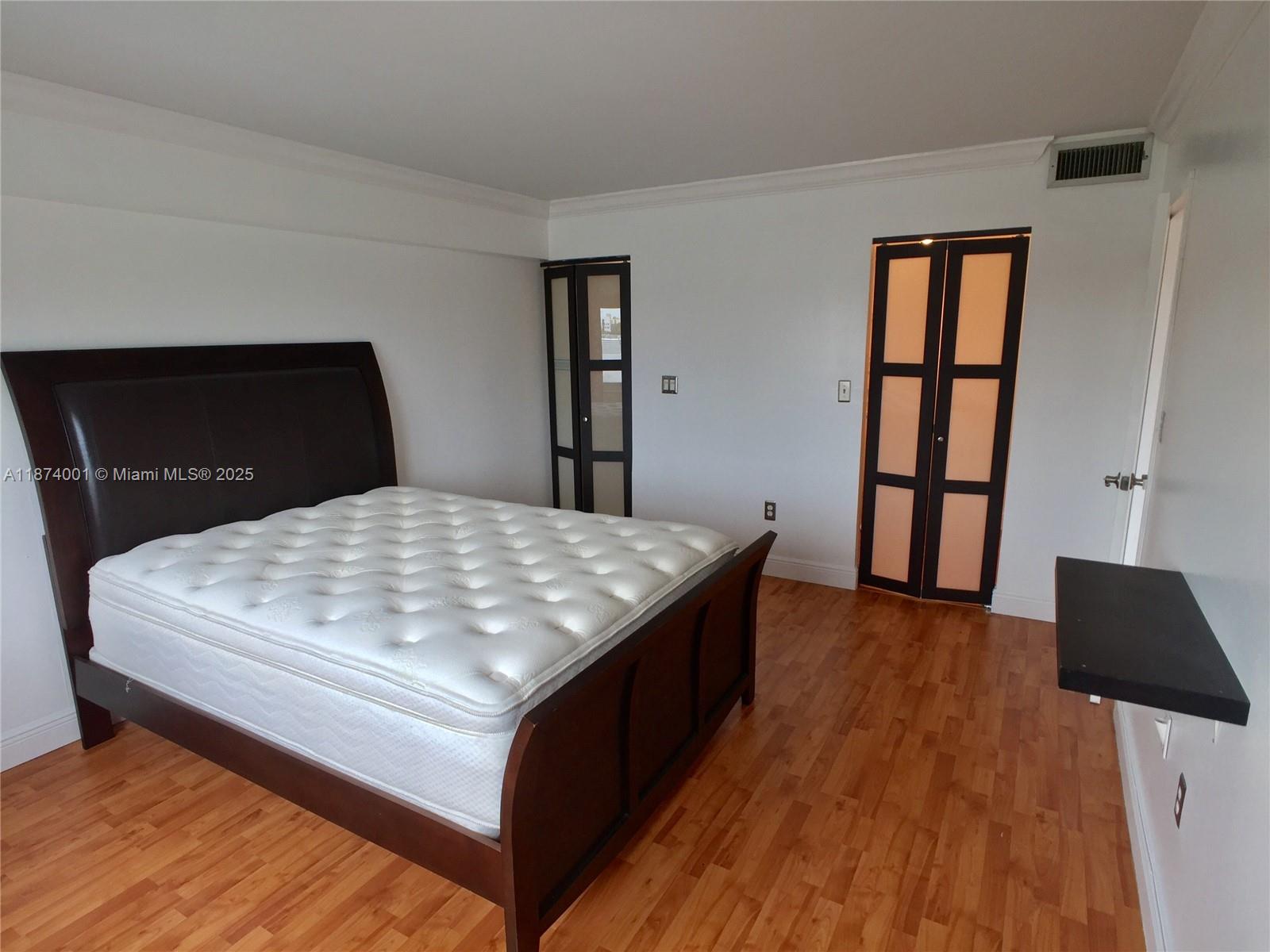 1025 Alton Road, Unit 507 Miami Beach, FL 33139 - Photo 7 of 28 a bedroom with a bed and a dresser