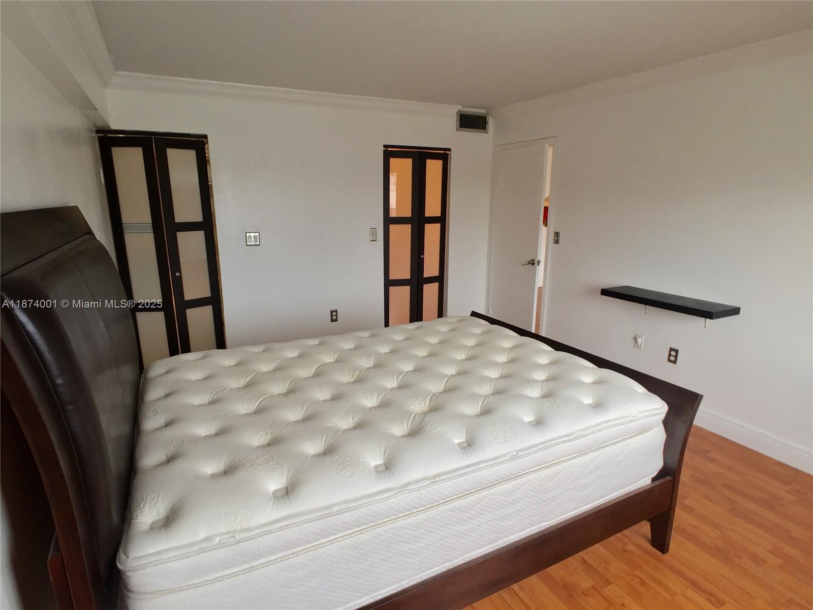 1025 Alton Road, Unit 507 Miami Beach, FL 33139 - Photo 8 of 28 a large bed sitting in a bedroom next to a window