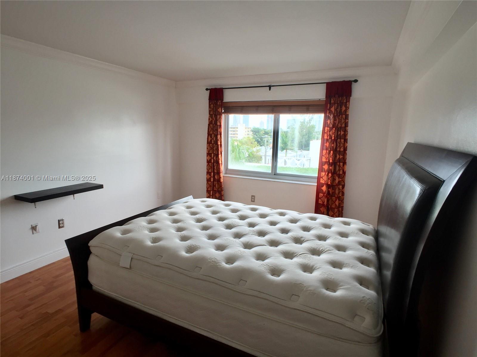 1025 Alton Road, Unit 507 Miami Beach, FL 33139 - Photo 9 of 28 a bedroom with a bed and a window