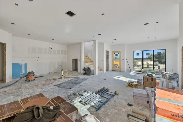 a living room with furniture stove and large window
