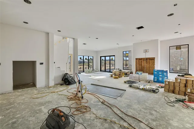 a room with a bed a couch and large window