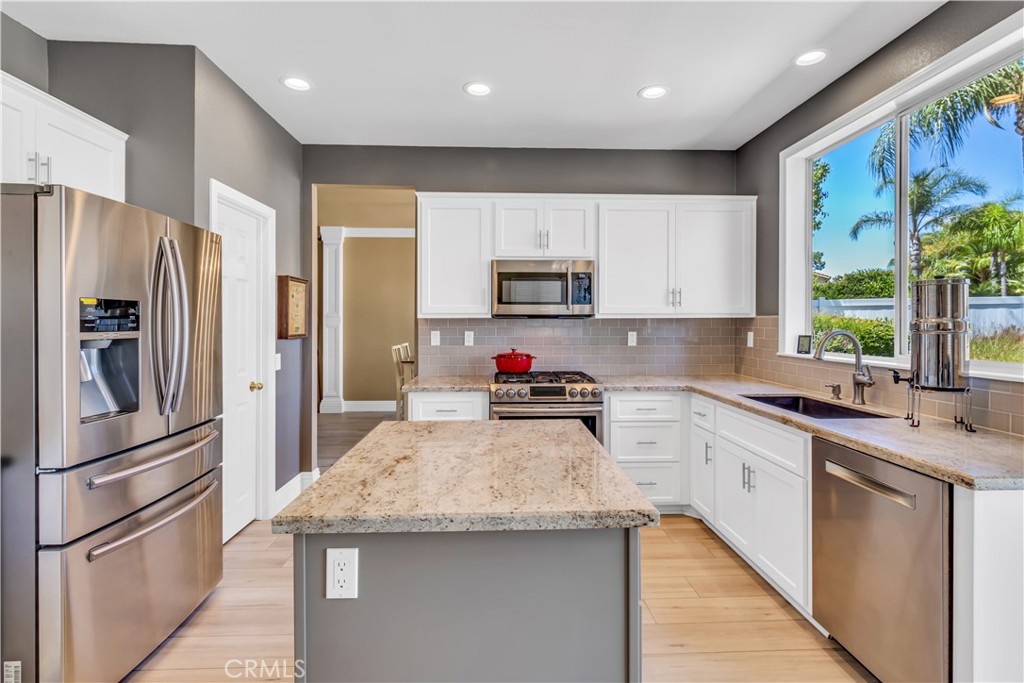 28308 Corte Ocaso Temecula, CA 92592 - Photo 14 of 43 a kitchen with granite countertop a refrigerator stove top oven and sink