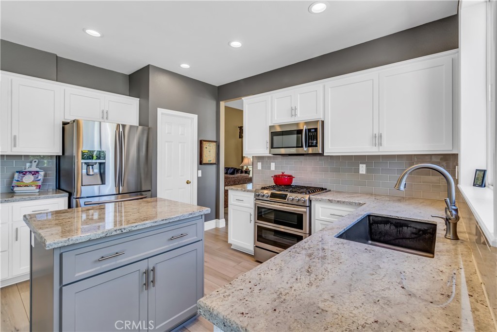 28308 Corte Ocaso Temecula, CA 92592 - Photo 15 of 43 a kitchen with stainless steel appliances a stove sink microwave and refrigerator