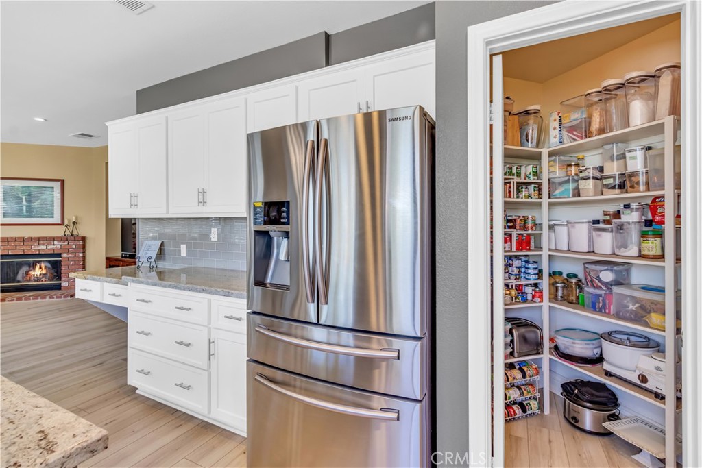 28308 Corte Ocaso Temecula, CA 92592 - Photo 16 of 43 a kitchen with stainless steel appliances a refrigerator and cabinets