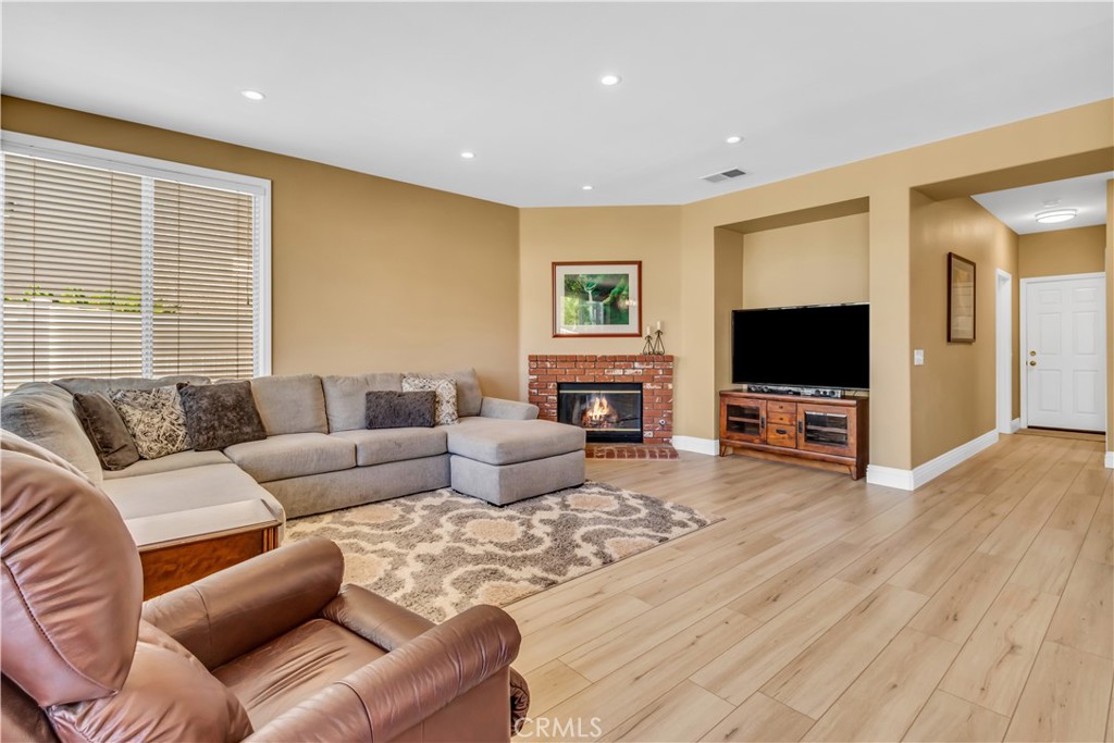28308 Corte Ocaso Temecula, CA 92592 - Photo 19 of 43 a living room with furniture a flat screen tv and a fireplace
