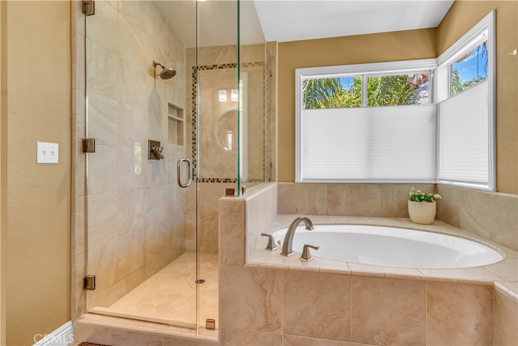 28308 Corte Ocaso Temecula, CA 92592 - Photo 27 of 43 a bathroom with a tub sink and shower